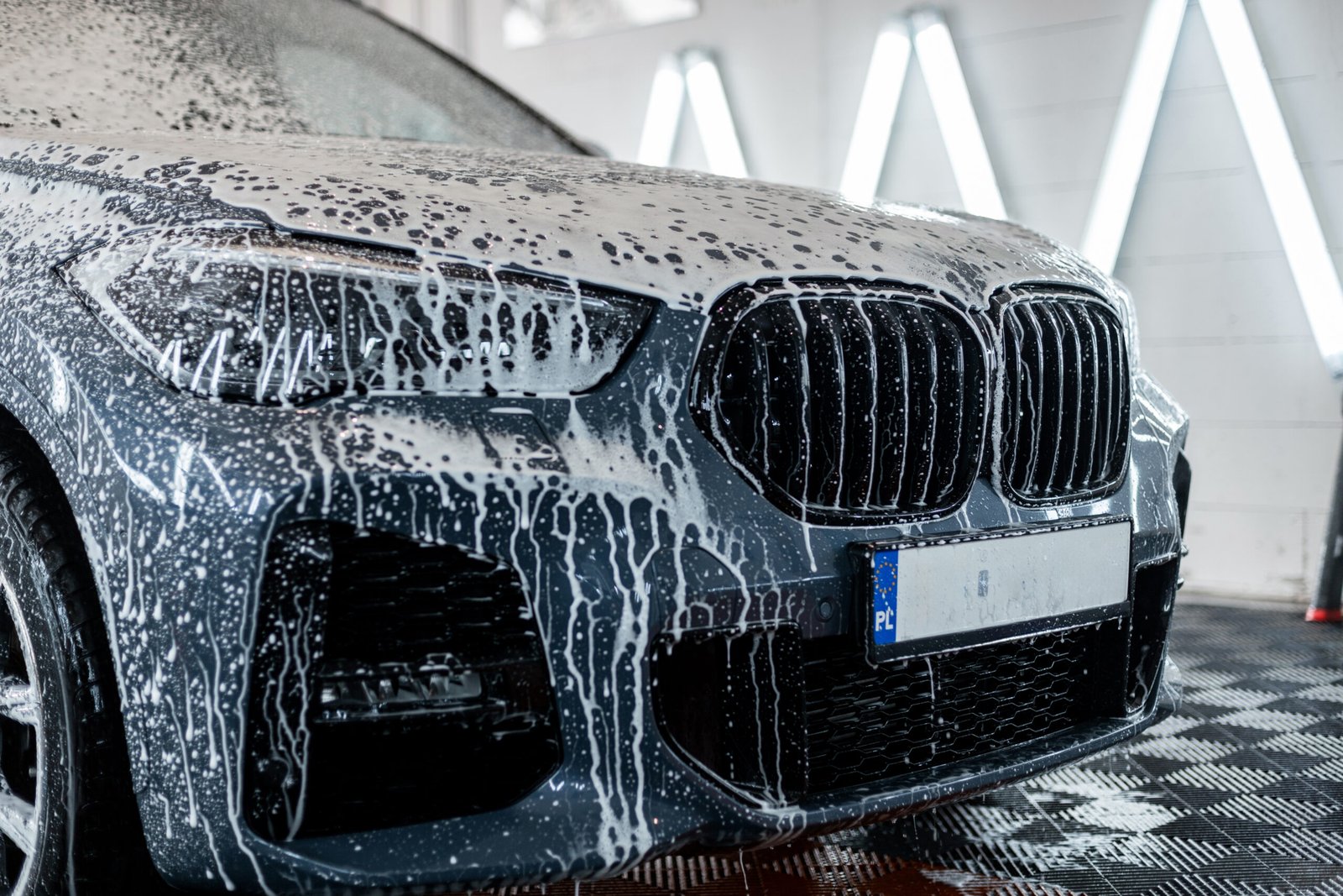 car-is-washed-professional-car-wash-man-washes-car-with-foam-detailing-1-scaled-1.jpg